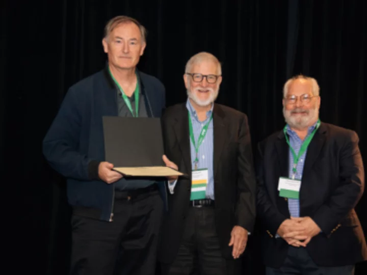 Dr. Hays holding award with two other researchers at ISOQOL in Ireland.